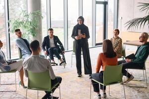 Corporate business team meeting with a manager or coach. Group of happy diverse, multiracial people sitting in a circle photo
