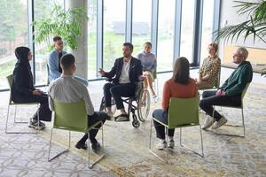 Corporate business team meeting with a manager or coach. Group of happy diverse, multiracial people sitting in a circle photo