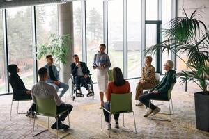 Corporate business team meeting with a manager or coach. Group of happy diverse, multiracial people sitting in a circle photo