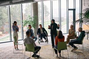 Corporate business team meeting with a manager or coach. Group of happy diverse, multiracial people sitting in a circle photo