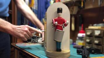 drummer drumming, wooden mechanical toy automaton, on table in workshop video