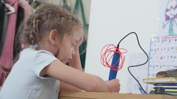 Cute girl using 3D pen to create art in study room at home video