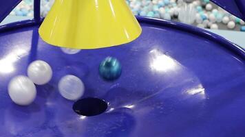 A collection of Colorful Transparent Balls cascading down a Funnel, creating a vibrant display video