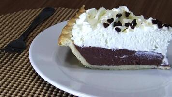 Tight Shot Of Chocolate Cream Pie Slice On White Plate And Placemat With Camera Movement video