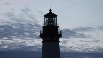 Silhouette Of Top Of Lighthouse Against Cloudy Sky At Dusk Newport Oregon video
