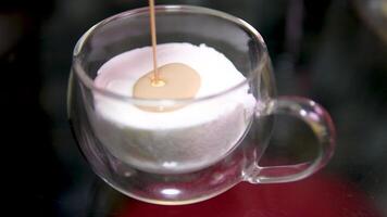 pour Baileys into ice cream Irish cream liqueur is poured into a glass with ice cubes. Empty green bottle. Alcoholic drinks at the bar. video