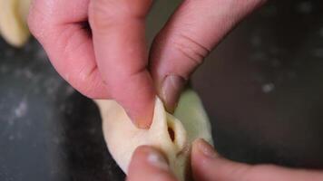 Hands shaping dough on floured surface video