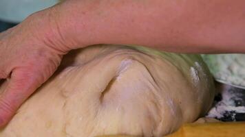 Close up view of bakers hands kneading the dough on the table. video