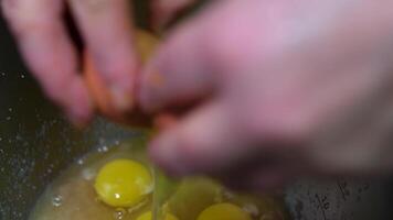 Crop lady breaking egg over bowl while preparing dough in kitchen stir yeast into dough video