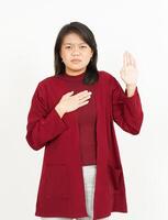 Swearing or Promise Gesture Of Beautiful Asian Woman Wearing Red Shirt Isolated On White Background photo