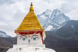 Ancient Tibetan Buddhist stupa with beautiful view of Mt.Ama Dablam located in Dingboche village Nepal. photo