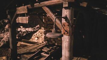 Old rustic lantern hanging under a wooden structure at a mining site video