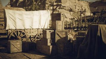 Historic wooden crates and wagon in a desert landscape during sunlight hours video