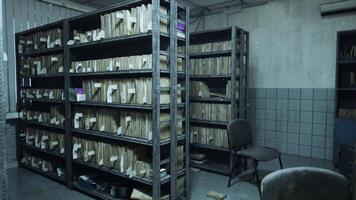 Abandoned hospital archive room with damaged records and empty chairs video