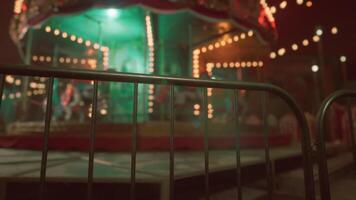 An abandoned amusement park at night with a deserted carousel brightly lit video