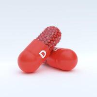 Vitamin D With Red Capsule, Granules and White Background photo
