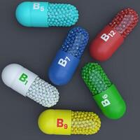 VitaminB1,B5,B6,B7,B9,B12 With Green, White,Yellow,Red,Blue and Turqoise Capsules, Granules and Dark Background photo