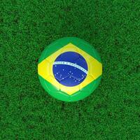 Flag Of Brazil On Soccer Ball With Grass Background photo