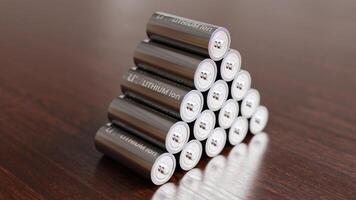 A pile of Lithium Ion batteries on wooden table photo