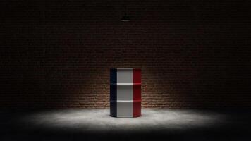 Oil barrel with the flag of France in front of a brick background photo