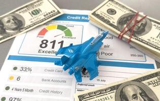 Credit score report document and toy plane on desk. photo