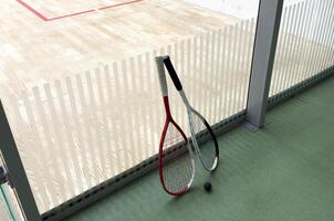 Sports, above and racket on squash court for competition, challenge and training center. Exercise, interior and empty room with top view of wooden floor of gymnasium for games, fitness club and gear photo