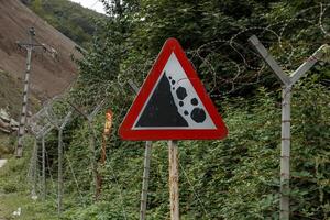 Warning sign near the border between Iran and Azerbaijan indicating landslide risk photo