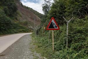 Border area between Iran and Azerbaijan with warning sign and barbed wire fencing photo