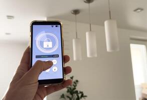Smart house, home automation, device with App icons. Man uses his smartphone with smarthome app to control the lights of his house. photo