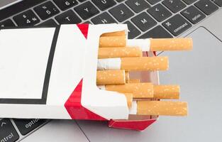 Close-up macro of cigarette on black keyboard photo