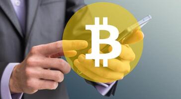 Close up of businessman hand pointing at golden bitcoin arrow and index on dark background. Cryptocurrency and financial growth concept photo