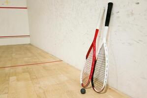 Sports, above and racket on squash court for competition, challenge and training center. Exercise, interior and empty room with top view of wooden floor of gymnasium for games, fitness club and gear photo