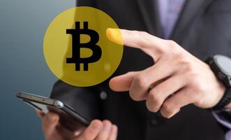Businessman holding smartphone and gold bitcoin, trader investor analyst buying cryptocurrency tokens analyzing stock market data investment risks using online trading mobile app concept. photo