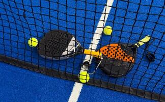 Padel tennis racket. Background with copy space. Sport court and balls. photo