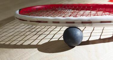 Sports, above and racket on squash court for competition, challenge and training center. Exercise, interior and empty room with top view of wooden floor of gymnasium for games, fitness club and gear photo