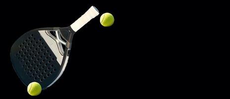 Background of black and white paddle tennis racket and two balls on a black table. Top view. photo