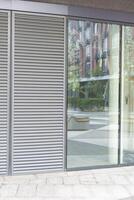 Abstract fragment of modern architecture, gray walls, glass and concrete. photo