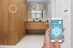 Young woman holding smart phone with launched security application at home. Concept of controlling and managing home security from a mobile device photo