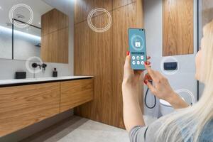 All the house in a phone. Close up of young woman user hands controlling electronic objects in modern luxury studio apartment via smart home interface on cell screen. Internet of things ios technology photo