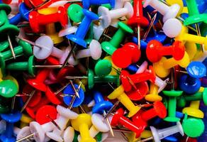 Collection of colorful push pins background, office stationery macro photo
