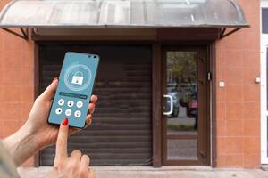 Cropped image of female entering secret key code for getting access and passing building using application on mobile phone, woman pressing buttons on control panel for disarming smart home system photo