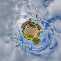 little planet and spherical aerial 360 panorama view on street ancient medieval castle with church and historic buildings with columns photo