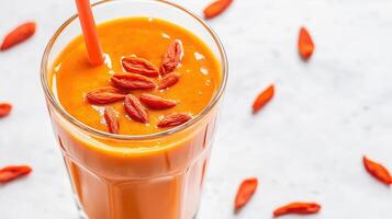 Bright orange smoothie with goji berries photo