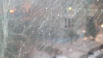 A view of the snow falling from a window video