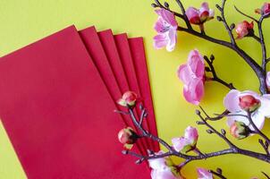 Top view of Chinese New Year decoration with red packets on yellow cover background with customizable space for text. Chinese New Year celebration photo