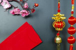 Chinese New Year decoration with red packets on black cover background with customizable space for text. Chinese New Year celebration. photo