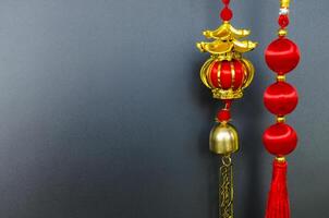 Chinese New Year lantern with hanging golden message meaning safe journey. Black cover background with customizable space for text photo