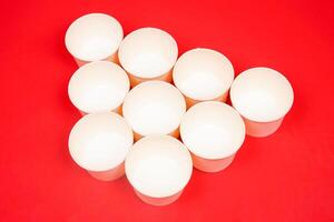 Top view of disposable kraft paper bowl, isolated on red background. High resolution photo. photo