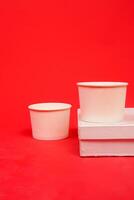 Disposable kraft paper bowls, isolated on red background. High resolution photo. photo