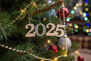 Close up view of the decorated Christmas tree with the numbers 2025 hanging on it. Happy New Year photo